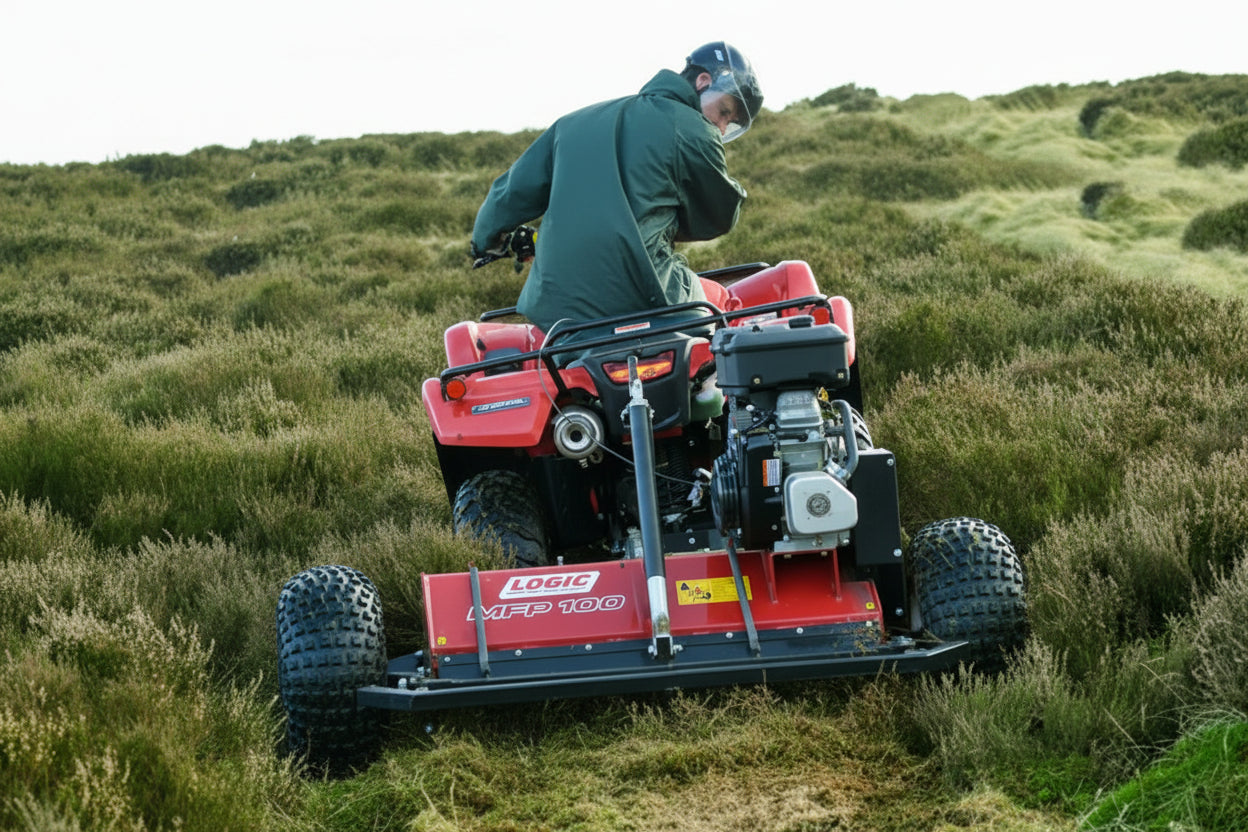 Person operating a red lawn mower on a grassy hillside Logic MFP100