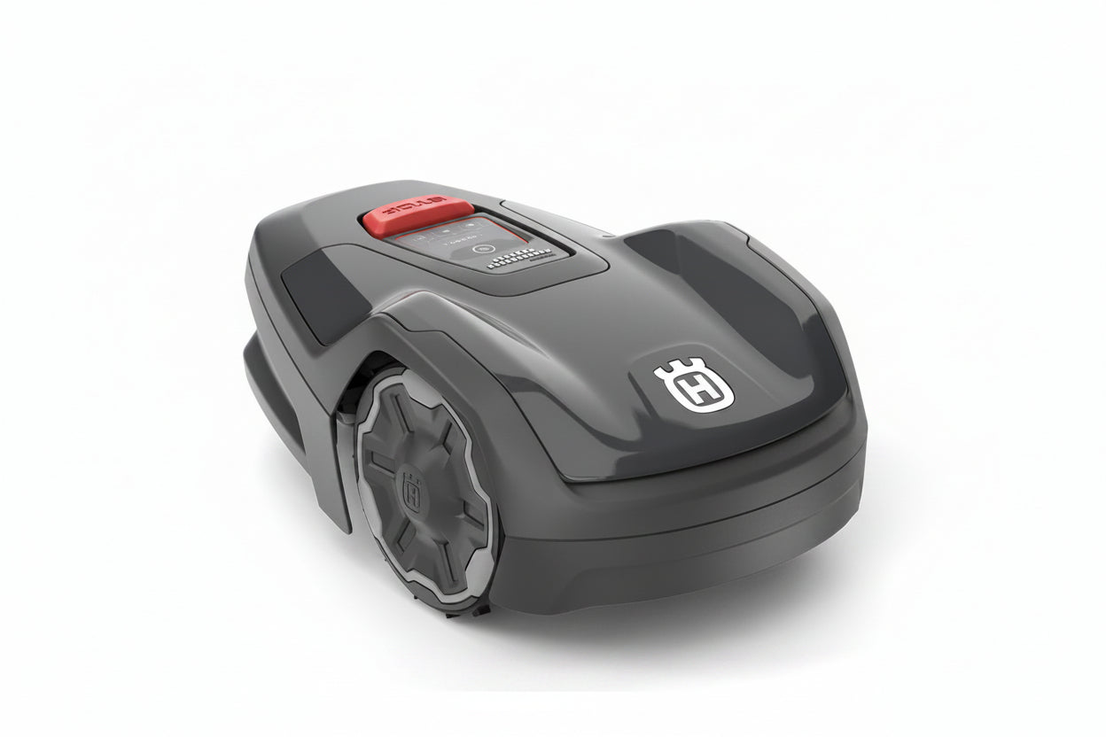 A Husqvarna robotic lawnmower in dark gray with a red button and a white Husqvarna logo on the front, shown on a light gray background.