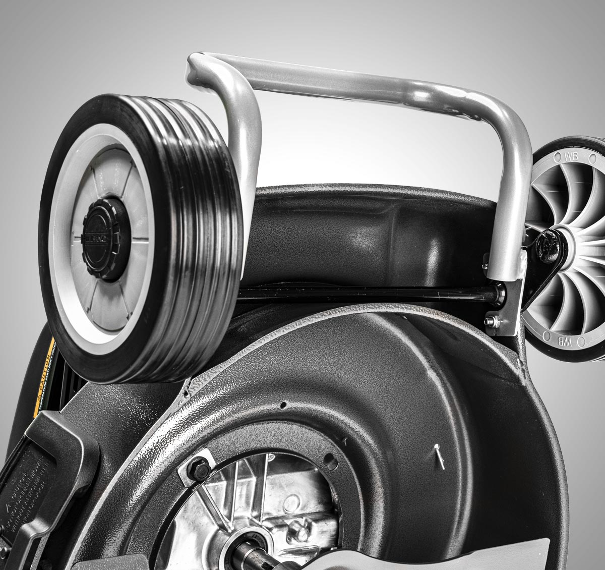 Close-up of a mechanical component with pulleys and belts on a gray background